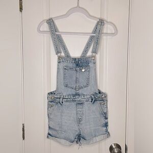 Short overalls. style this with some cowboy boots, white fitted tee & cowboy hat